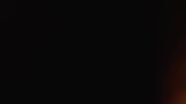 Minimalist black backdrop with a soft orange glow, evoking a sense of intrigue and depth. Ideal for backgrounds, digital art, or visual storytelling in contemporary media