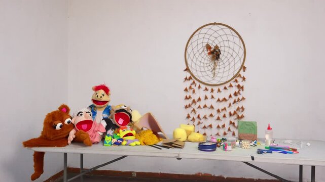 Artisan creating colorful hand puppets in workshop