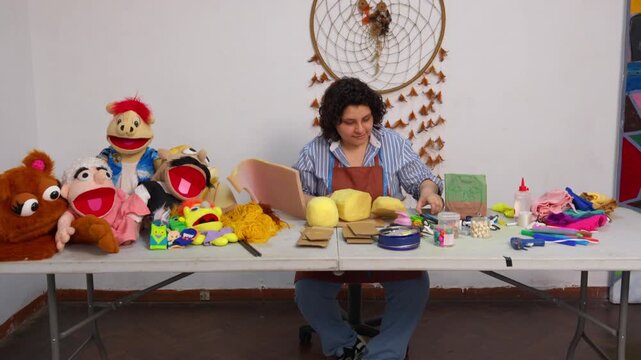 Artisan woman creating a hand puppet in her workshop