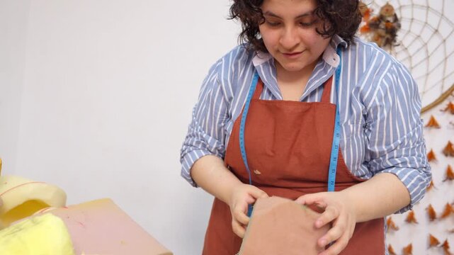 Female artisan creating puppets in her workshop
