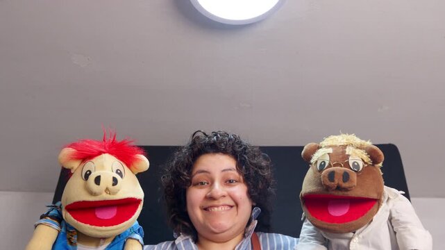 Puppeteer performing a puppet show with two funny pig characters