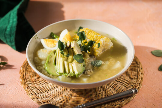 Traditional Ajiaco Colombiano - Colombian Soup with potato, chicken, avocado