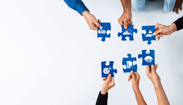 Hands coming together to fit puzzle pieces in a business setting, symbolizing teamwork, strategy, and collaboration for effective management solutions. Amity