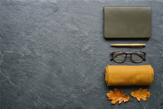 Autumn urban lifestyle essentials arranged on dark slate