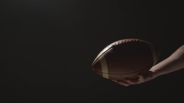 Close Up Studio Shot Of American Football Player Throwing And Catching Ball 5