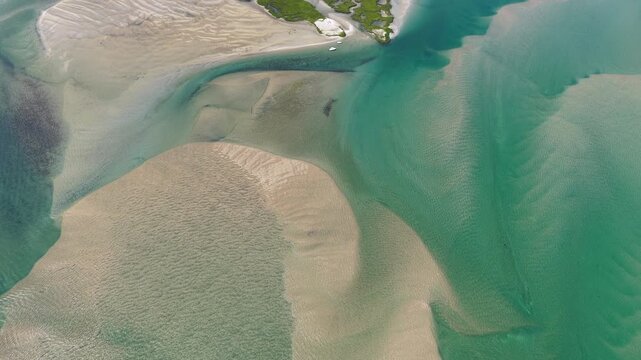 Currents from the Atlantic Ocean continuously shape the sand bars and scenic beaches of Cape Cod, Massachusetts. The entire peninsula is in constant movement due to its geologic makeup of mostly sand.