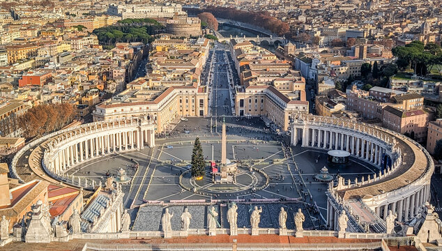 The panoramic view of Saint Peter's Square from the top of Basilica's dome on a sunny day.