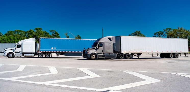 Freightliner trailer transportation. Rig truck trailer hauling. American style truck. Transport concept. Road freight cars. Trucking with semitruck vehicle. Semi truck in America. Logistics transport