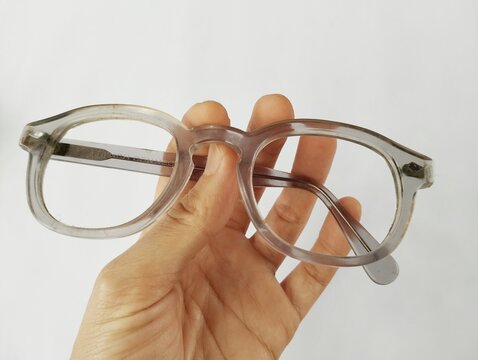 Old broken eyeglasses on white background