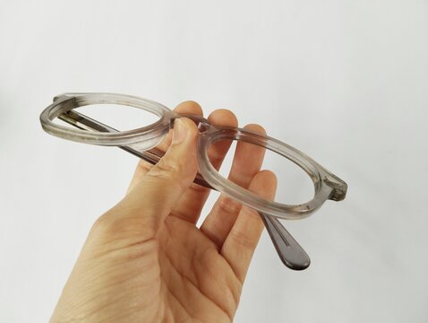Old broken eyeglasses on white background