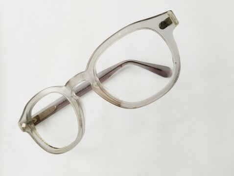 Old broken eyeglasses on white background