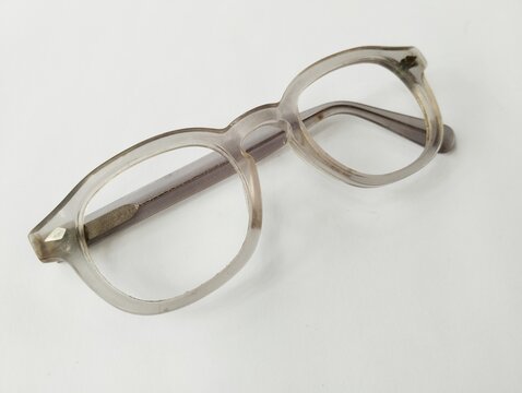 Old broken eyeglasses on white background