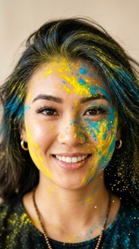 Portrait of young woman with colorful powder paint. Holi festival celebration concept.