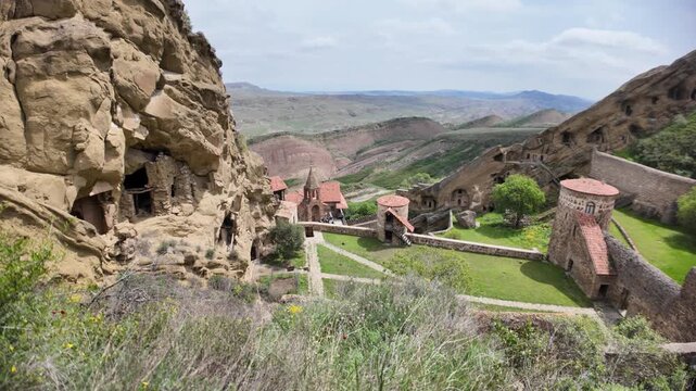 David Gareji monastery complex presents ancient cave structures and church buildings carved into desert hillsides, reflecting historical religious architecture and unique cultural landmark in Georgia