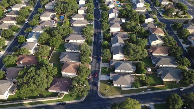 Magnolia Park Drive master planned community dense housing lanes connect single family suburban houses near Culebra Road. Vehicles line paved driveways beside fenced backyard lawns, San, TX