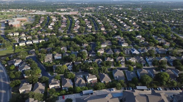 Suburban transit corridors adjoin master planned community single family suburban houses near West Military Drive. Complex rooflines border dense housing residential tree canopies, San, TX