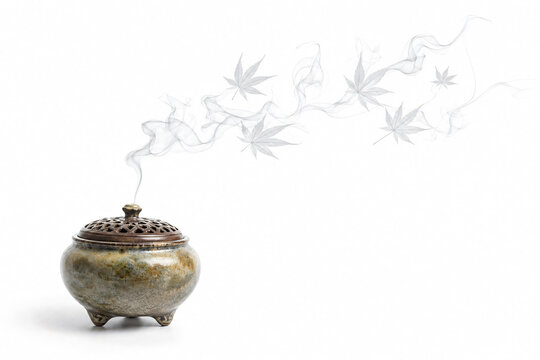 Japanese incense burner koro releasing swirl of fragrant smoke shaped like maple leaves concept autumn white background