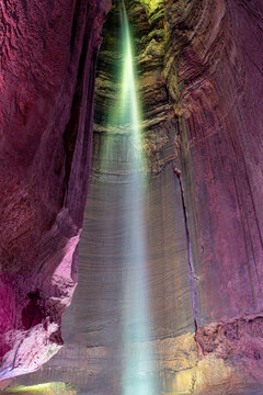 Low angle view of Ruby Falls underground waterfall illuminated with colorful lights inside Lookout Mountain cave