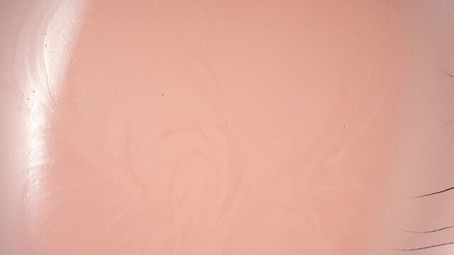 Top-down time-lapse of a flat orange surface drying, forming cracks and a fragmented texture resembling natural mudcracks
