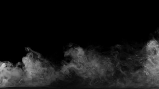 Smoke billows across the lower frame against a pitch black backdrop.