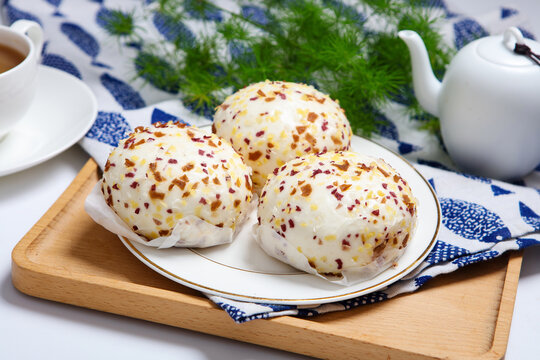 Three colorful crispy crumb coated steamed buns white plate grid tablecloth