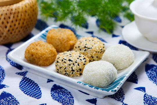 Assorted glutinous rice mochi coconut sesame coated square ceramic plate