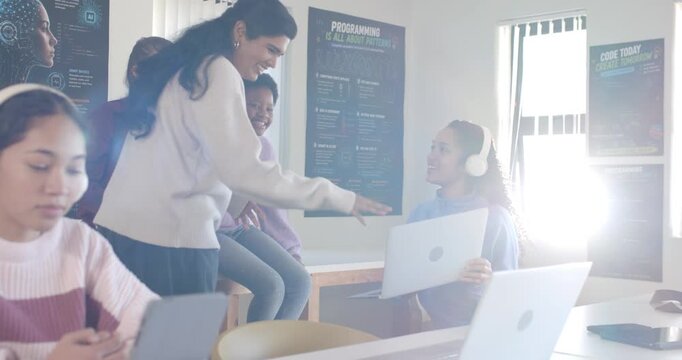 Diverse female students in lab leaning and gesturing, laptop user sharing screen collaborating