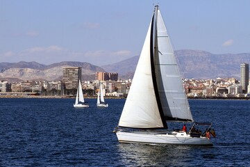 Sailboats sailing near the Mediterranean city of Alicante, Spain. © Jose Lledo