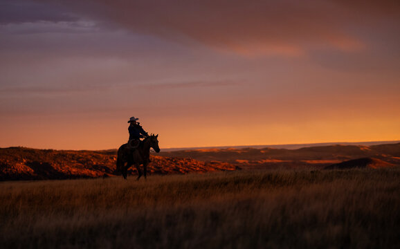 Cowgirl on horse Golden hour sunrise sunset