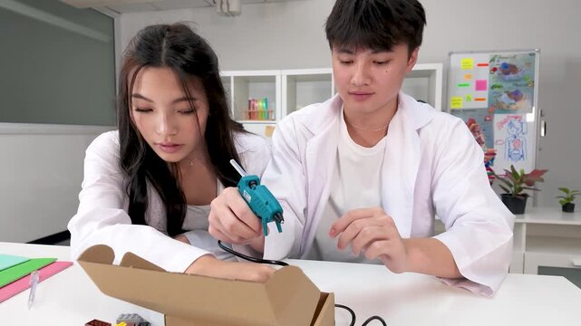 Thai Science Students Using Glue Gun on Project in Bangkok Classroom