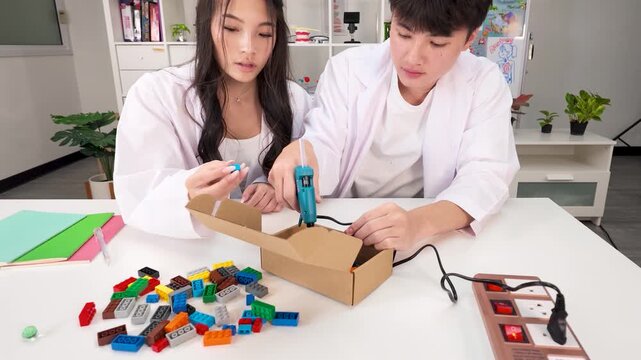 Thai Students Using Glue Gun on Science Project in Bangkok Classroom