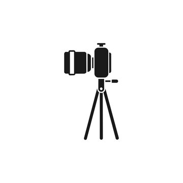 A black vector icon depicting a professional DSLR camera with a telephoto lens mounted on a sturdy tripod stand, set against a plain white background.
