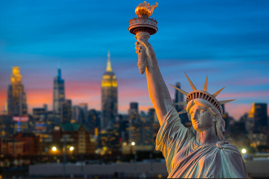 Statue of Liberty Close Up at Twilight with New York City Skyline and Empire State Building, USA