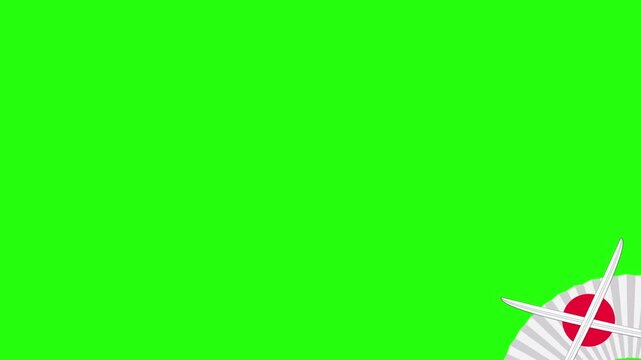 Fan featuring a Japanese flag design sits in the corner of a vivid green screen frame to provide a cultural aesthetic element that can be easily masked for various creative compositions and video.