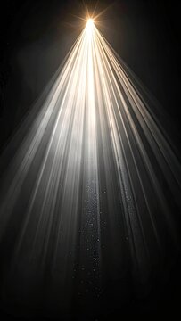 A bright light beam shines down from above, illuminating particles in the air.