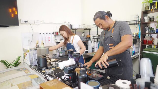 Small business entrepreneur coffee shop cafe restaurant. Asian man barista using manual espresso maker making freshly brewed coffee on bar counter. Waitress serving beverage drink to customer.