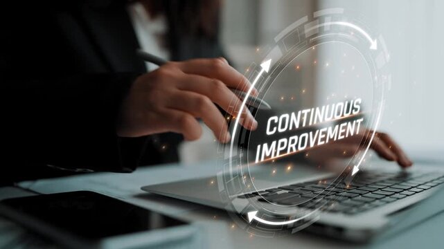Focused Business Professional Engaging in Continuous Improvement Using Technology While Working on Laptop in Modern Office Environment Sigmoid