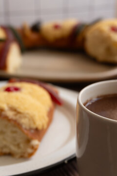 Close up to a cup of chocolate, in the background "Rosca de Reyes" or Epiphany bread. January 6 Celebration