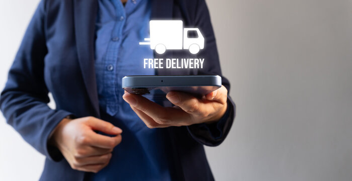 Hand holds phone with holographic truck symbol. White icon floats above device, labeled "FREE DELIVERY."