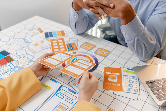 A UX designer presents wireframes, interface layouts, and mobile app concepts during a collaborative design workshop, improving user experience, product strategy, and digital interface planning.