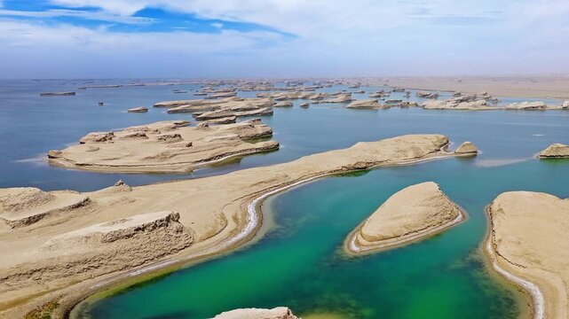 Aerial view of water yardang landforms surrounded by turquoise water in Qinghai, China