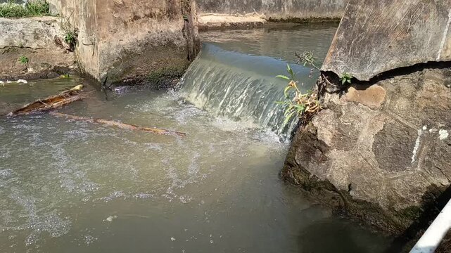 Small Waterfall in Concrete Irrigation Canal with Flowing Water