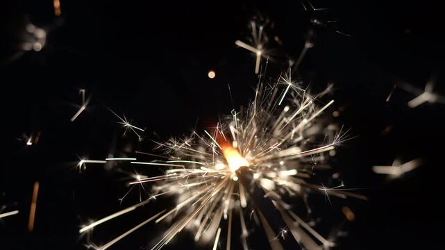 Sparkling Sparkler Emitting Glowing Light and Sparks on Dark Background 4K