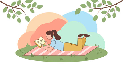 Woman relaxing on a blanket reads a novel under a tree in a lush green outdoor environment.