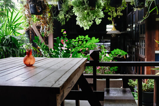 Wooden terrace with flowers and plants in pots on the balcony