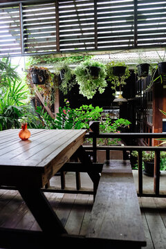 Wooden terrace with flowers and plants in pots on the balcony