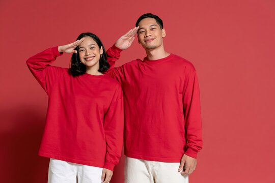 Indonesian Independence Day celebration with young couple. Patriotic national holiday scene with festive attire and joyful mood.