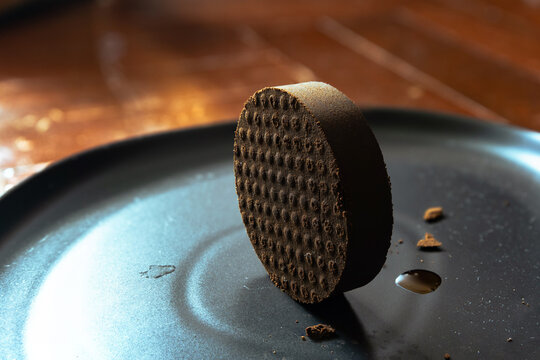 Perfect Espresso Coffee Puck Standing Balanced on Its Edge