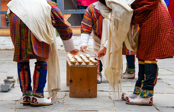 Bhutan, the 20th of october during the Jakar Festival in Bumthang men light candles inside the monastery.