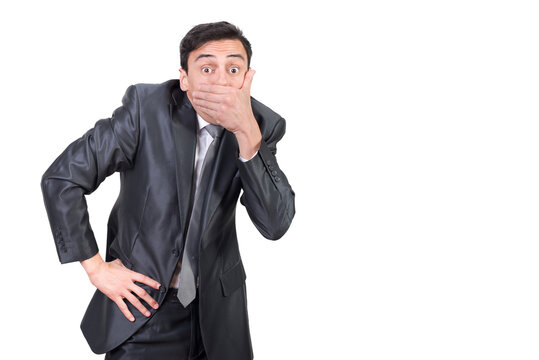Talkative man in suit covering mouth with hand